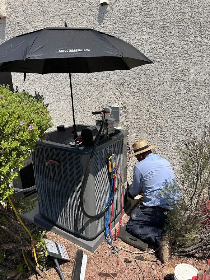HVAC technician performing outdoor AC maintenance in Humboldt